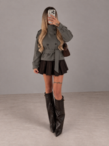 Model wearing Funnel Neck Trench Coat Dark Grey in a grey studio