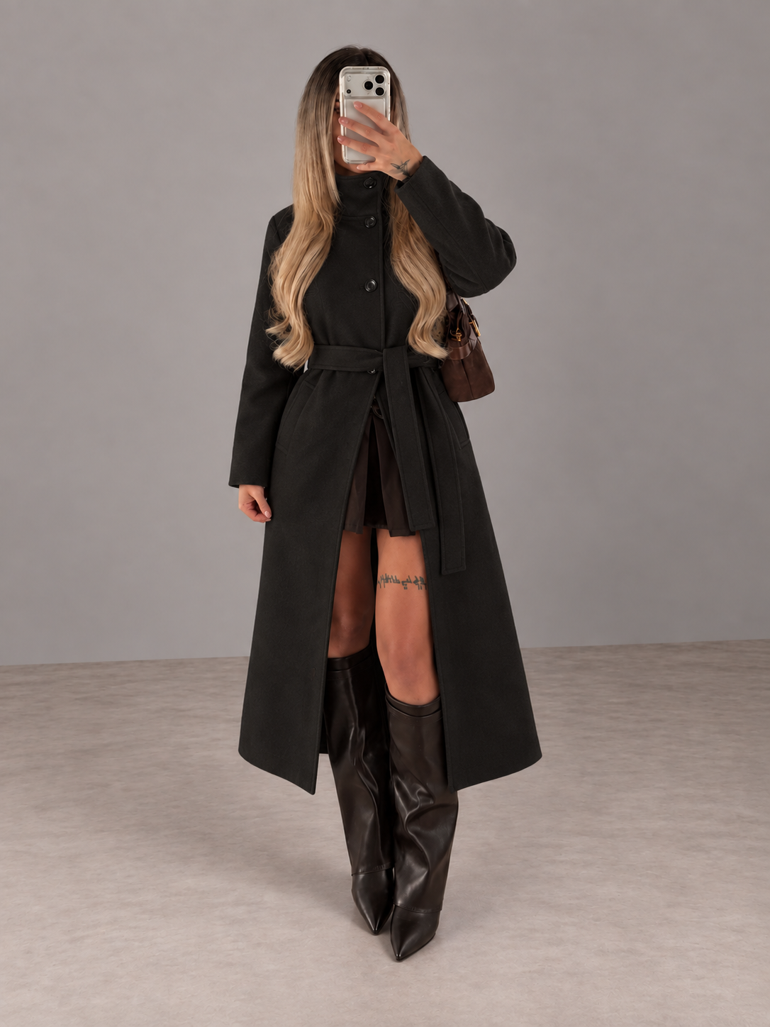 Model wearing Long Coat Black in a grey studio